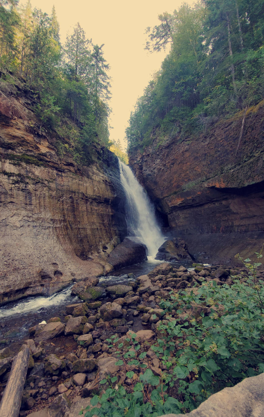 Miners Falls, Upper Peninsula Michigan — the Miners River plunges over a sandstone crest, framed by moss-covered walls and old-growth forest in Pictured Rocks National Lakeshore.
